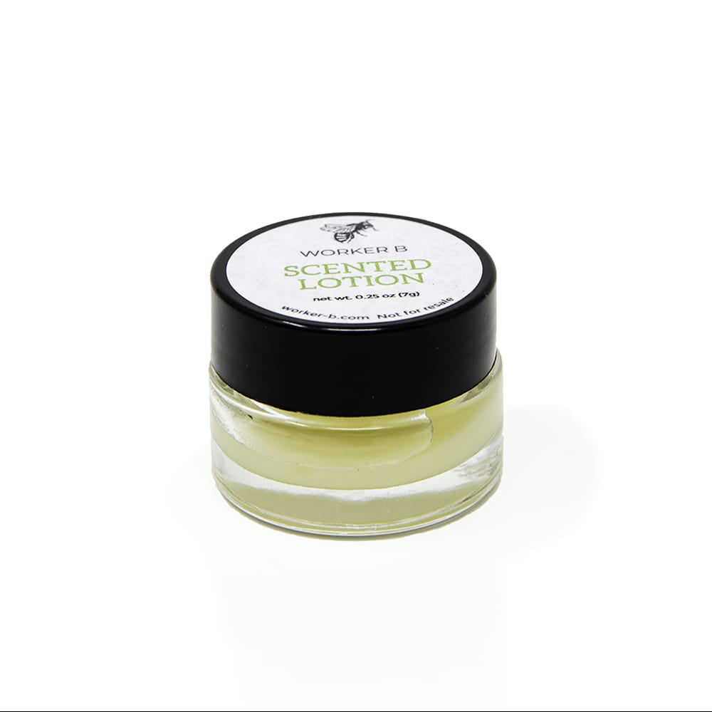 A small glass jar with a black lid containing a yellowish cream, labeled as 'Autumn Lotion (Travel)'