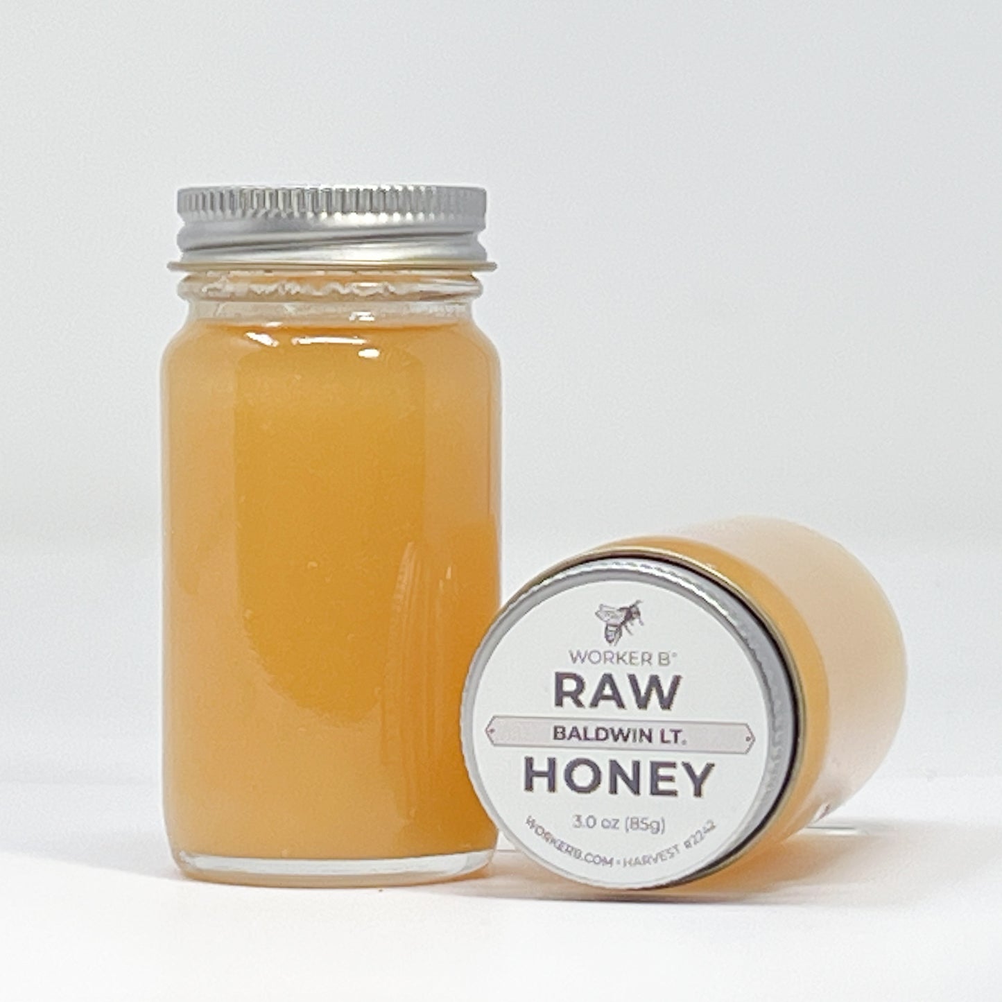 Jar of honey with a label on a white background