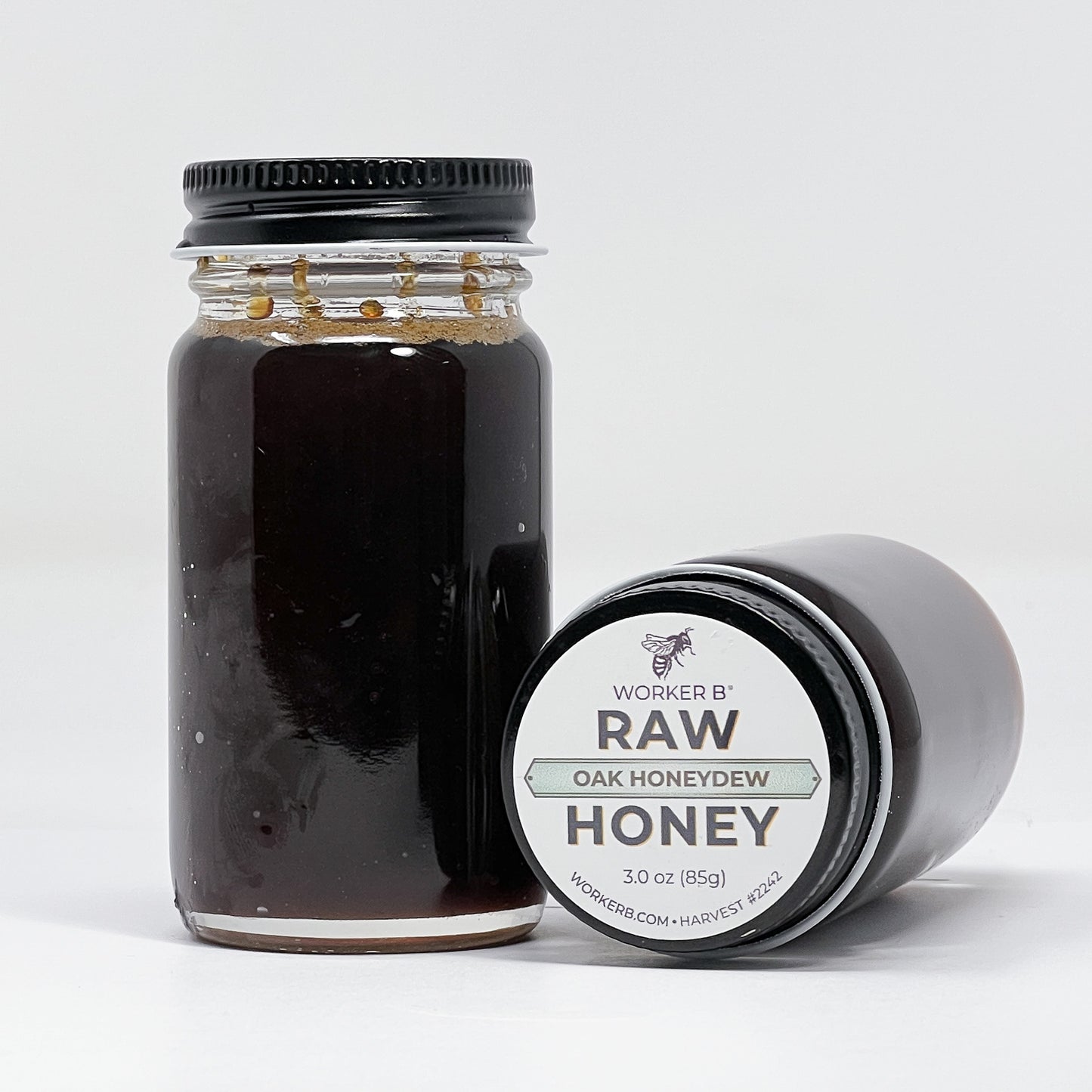 Jar of raw honey with a label on a white background