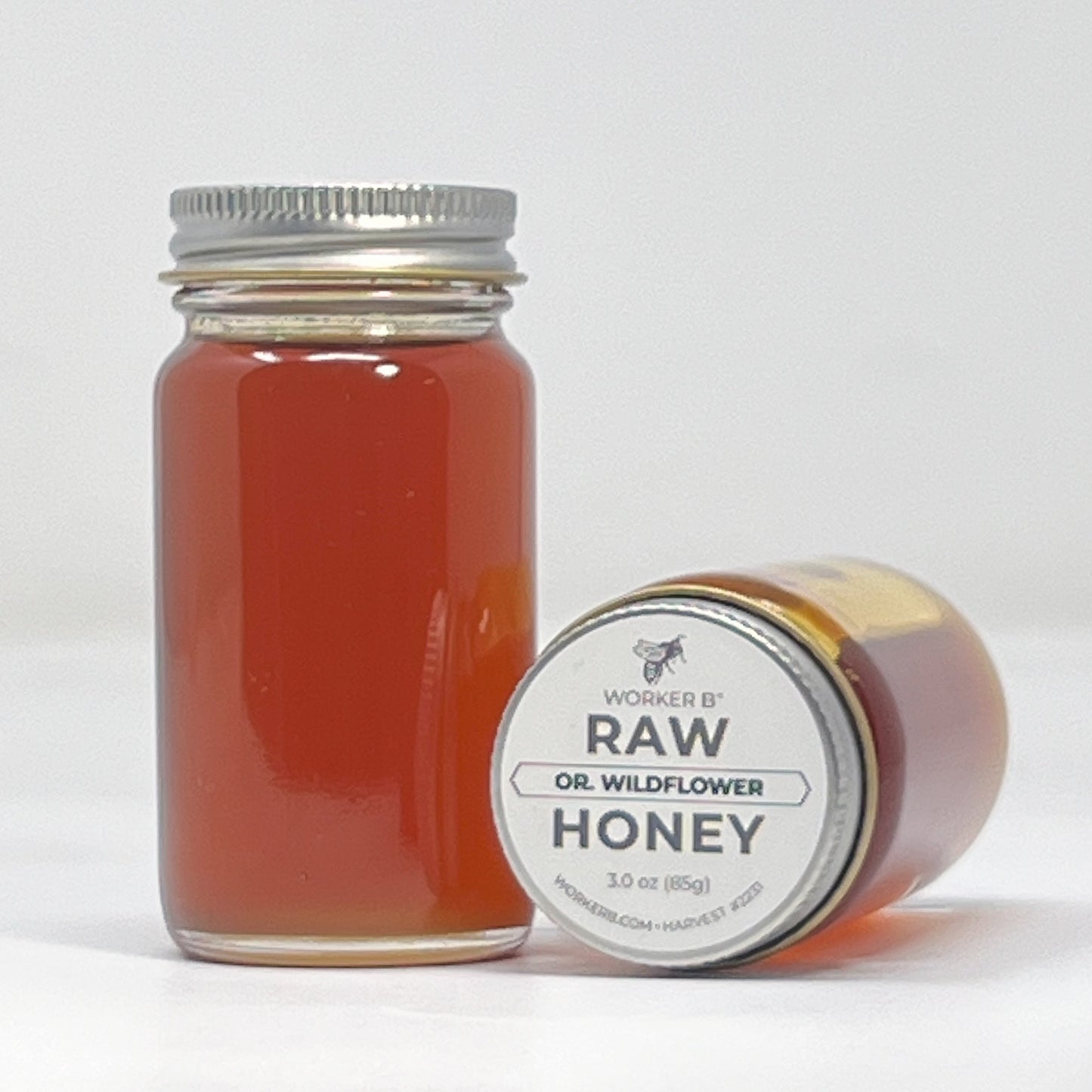 Jar of raw wildflower honey with a label on a white background