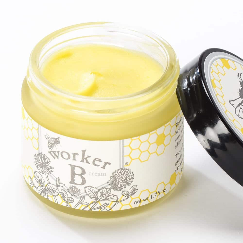 Jar of cream with a honeycomb design label on a white background