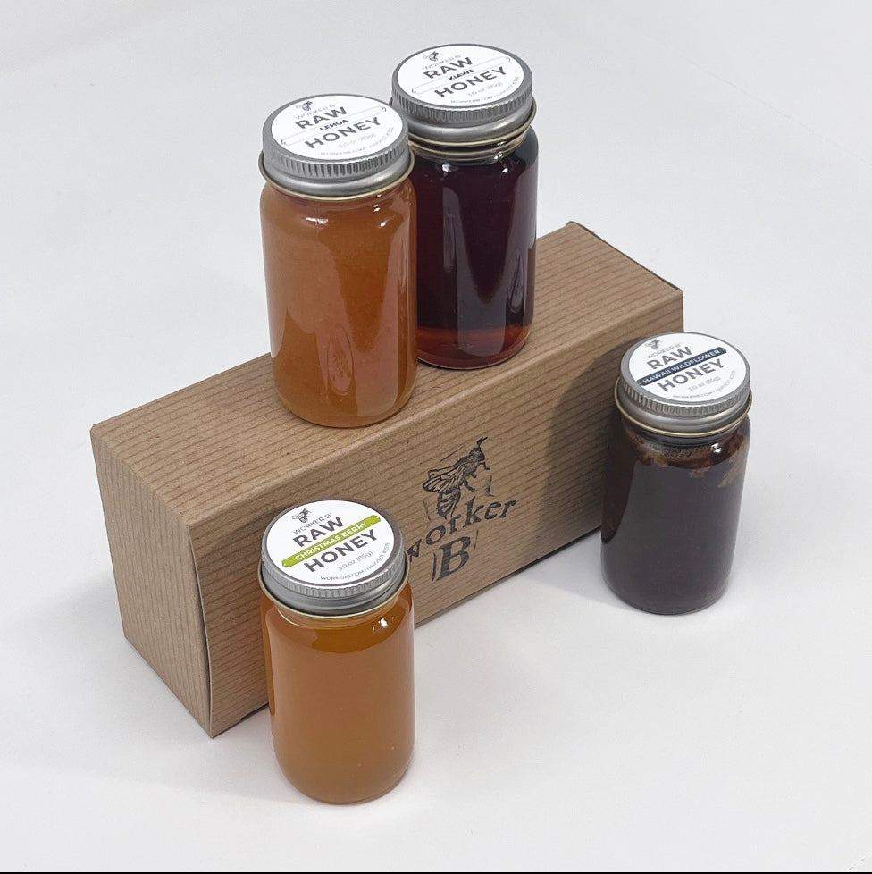 Four jars of raw honey on a wooden stand with 'Worker B' branding.