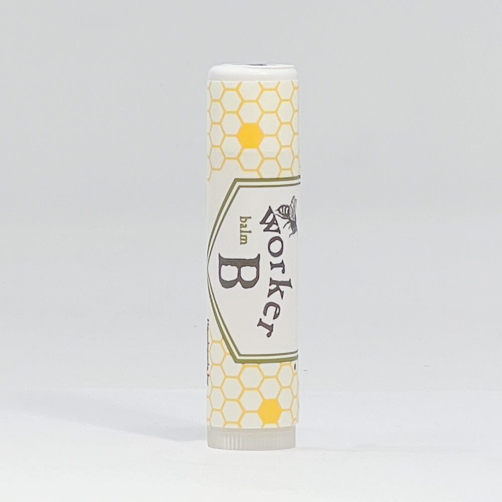 Lip balm with honeycomb design and 'Worker B' branding on a gray background