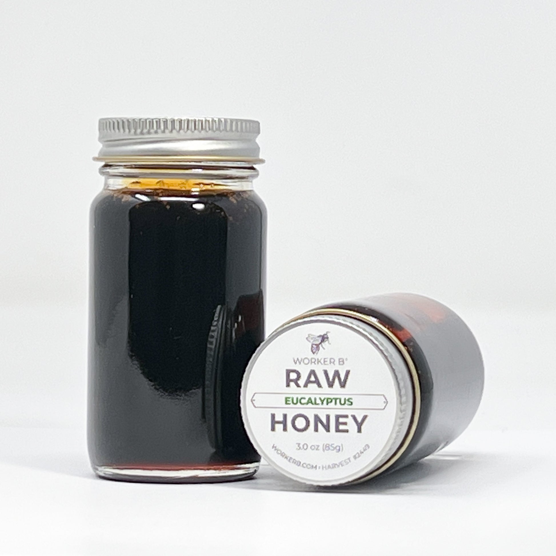 Jar of Worker B Raw Eucalyptus Honey on a white background