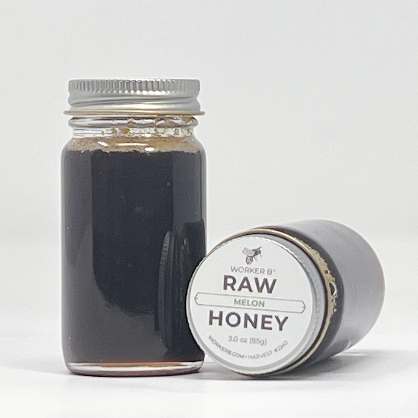 Jar of raw honey with a label on a white background