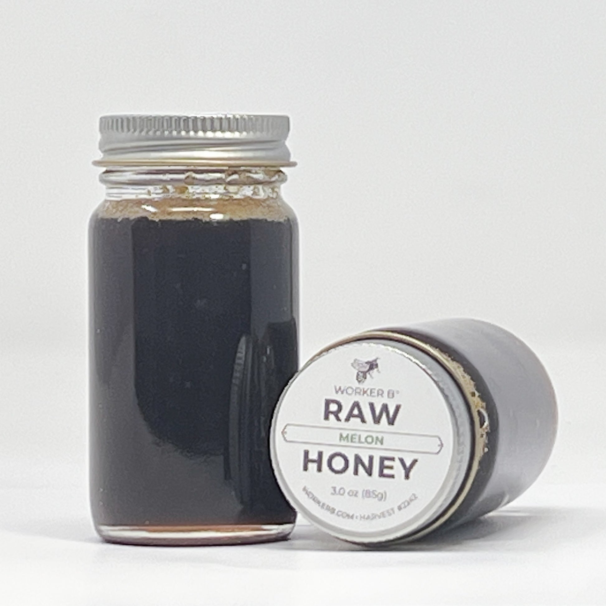 Jar of raw honey with a label on a white background