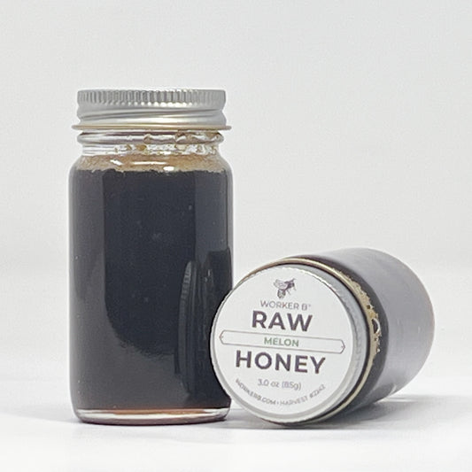 Jar of raw honey with a label on a white background