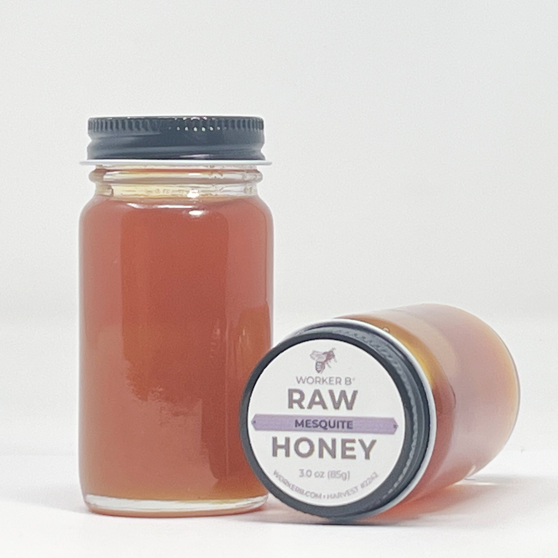 Jar of raw mesquite honey with a label on a white background