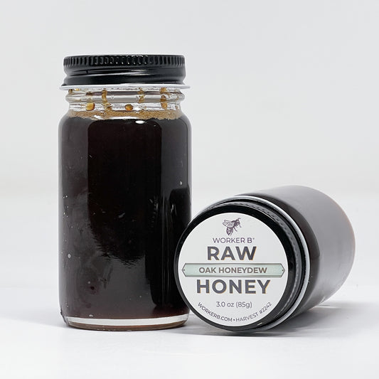 Jar of raw honey with a label on a white background