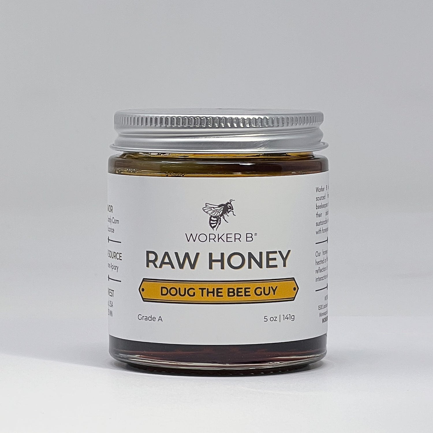 Jar of raw honey with 'Worker B' label on a white background
