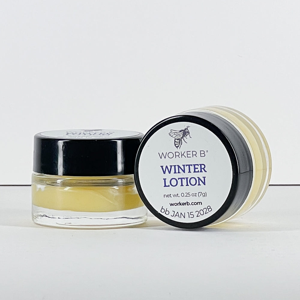 Small jar of Worker B' winter lotion with black lid on a white background
