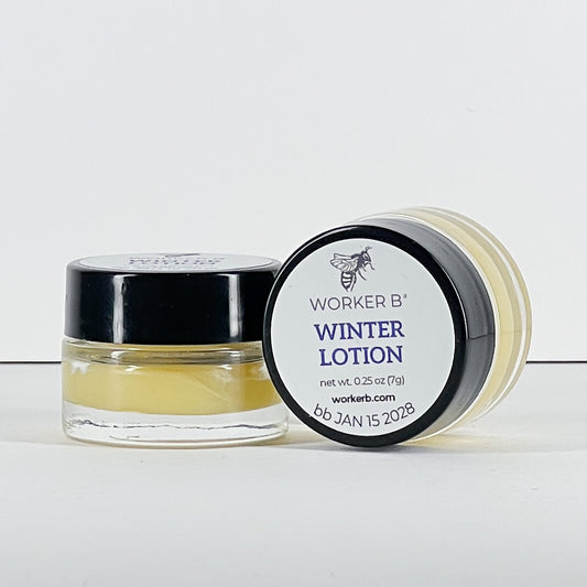 Small jar of Worker B' winter lotion with black lid on a white background